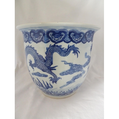 177 - A Chinese fish bowl jardiniere, decorated in blue with a coiled five claw dragon chasing a flaming p... 