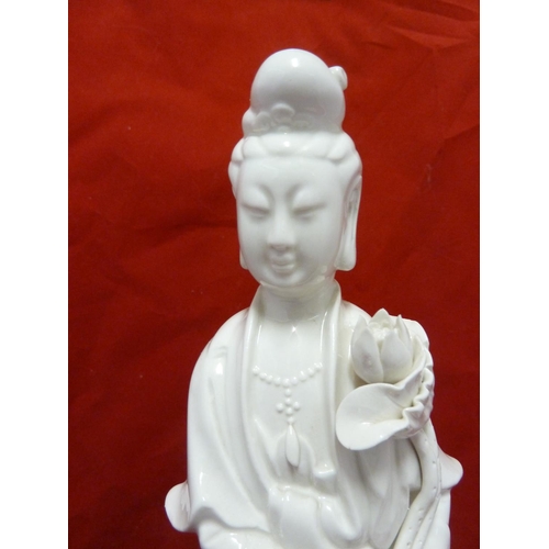 179 - A Dehua Chinese porcelain figure of Guan Yin, standing holding a large lotus flower the base similar... 