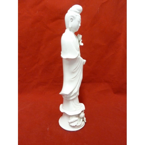 179 - A Dehua Chinese porcelain figure of Guan Yin, standing holding a large lotus flower the base similar... 