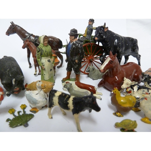 138 - A Britain's lead farmers cart and driver; other lead farmyard figures; and a 'porky pig' type lead f... 