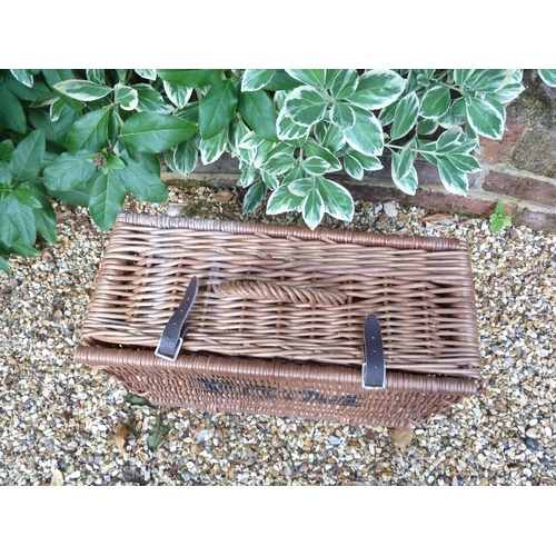 140 - A Fortnum and Mason wicker picnic hamper, with leather strap ties, 48cm max.