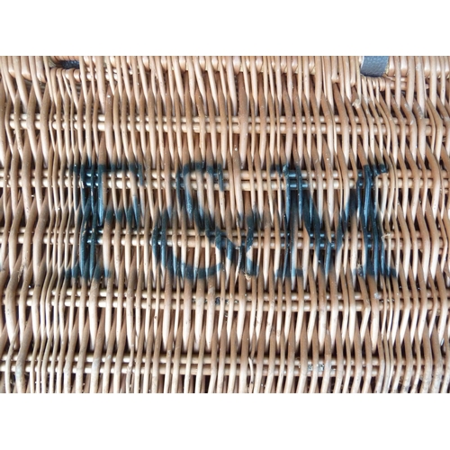 140 - A Fortnum and Mason wicker picnic hamper, with leather strap ties, 48cm max.