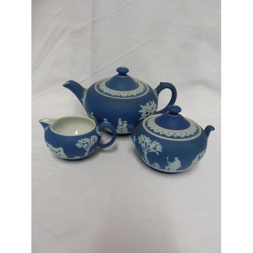 187 - A three piece Wedgwood Portland blue jasper tea set, sprigged in white with classical figures in a g... 