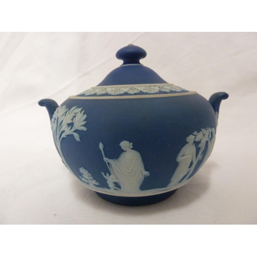 187 - A three piece Wedgwood Portland blue jasper tea set, sprigged in white with classical figures in a g... 