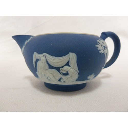 187 - A three piece Wedgwood Portland blue jasper tea set, sprigged in white with classical figures in a g... 