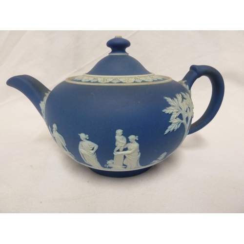 187 - A three piece Wedgwood Portland blue jasper tea set, sprigged in white with classical figures in a g... 