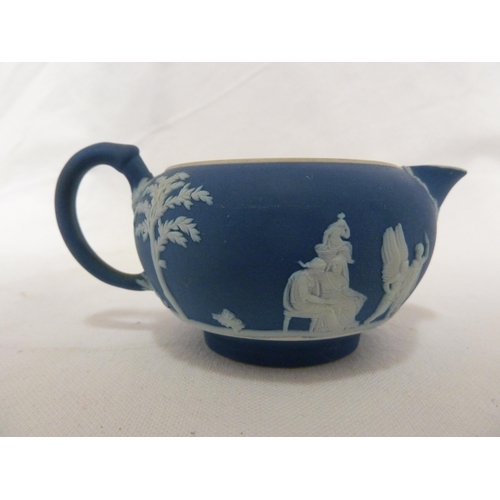 187 - A three piece Wedgwood Portland blue jasper tea set, sprigged in white with classical figures in a g... 