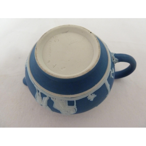 187 - A three piece Wedgwood Portland blue jasper tea set, sprigged in white with classical figures in a g... 