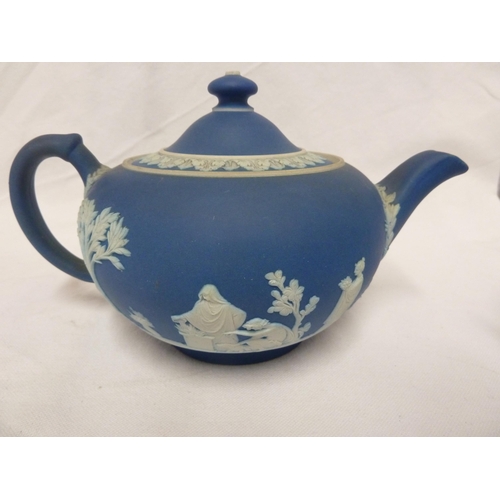 187 - A three piece Wedgwood Portland blue jasper tea set, sprigged in white with classical figures in a g... 