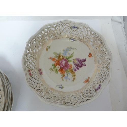 204 - A Schumann, Baveria porcelain dessert service, decorated with Summer flowers within pierced 'ribbon'... 