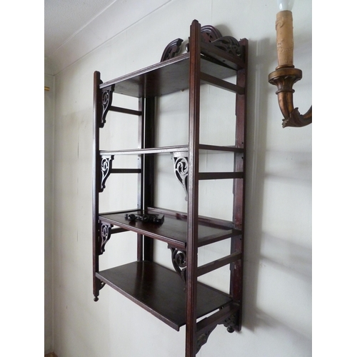 200 - A set of folding hanging shelves, with pierced brackets and beneath a broken pediment with vase fini... 