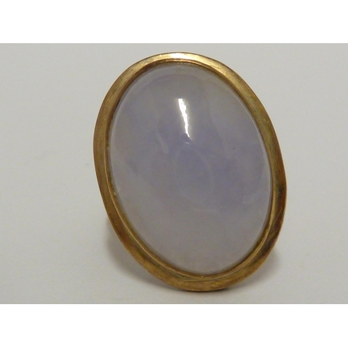 30 - A lavender jade cabochon, set in yellow metal marked 14K, ring size J, 6grms total weight.