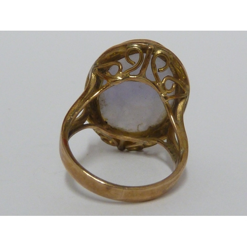 30 - A lavender jade cabochon, set in yellow metal marked 14K, ring size J, 6grms total weight.