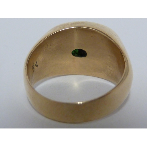 31 - An apple green hardstone, set in yellow metal rub over setting marked 9K, tests as Jade, ring size G... 