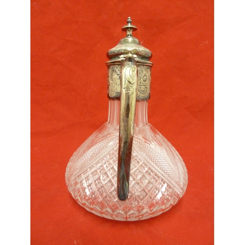 37 - A cut glass claret jug with silver plated mounts