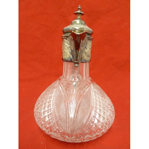 37 - A cut glass claret jug with silver plated mounts