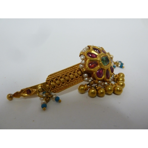 40 - A Kashmiri gem set bar brooch, the central emerald encircled by eight rubies within strung seed pear... 