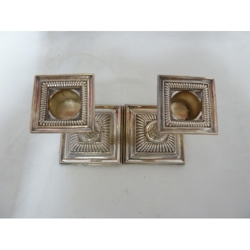 5 - A pair of silver plated candlesticks, of reeded columns and stepped square foot, with unusual square... 