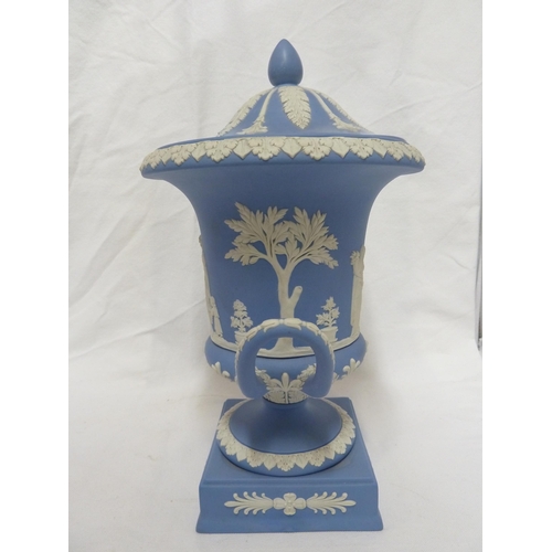 77 - A Wedgwood pale blue jasper urn and cover, the body sprigged with classical maidens over a square pl... 