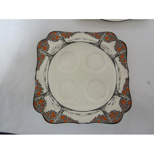 81 - A Crown Ducal Ware Orange Tree pattern cheese dish and cover; two egg stands; and fice egg cups, Reg... 