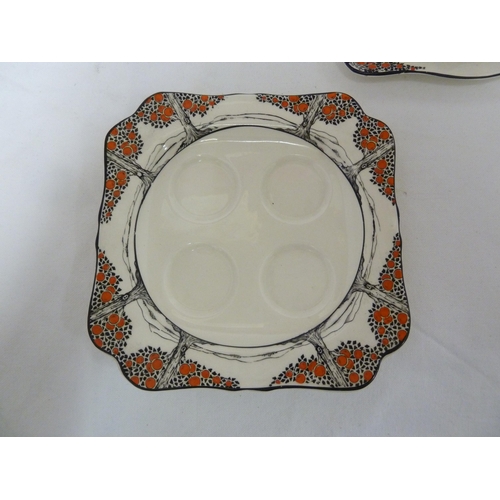 81 - A Crown Ducal Ware Orange Tree pattern cheese dish and cover; two egg stands; and fice egg cups, Reg... 