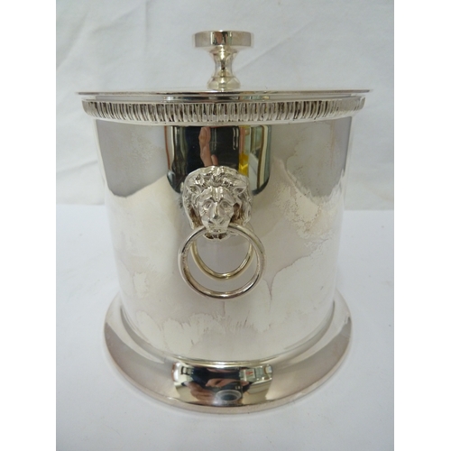 2 - A silver plated biscuit box and cover, circular with lion head and ring handles, 14 cm high approx.