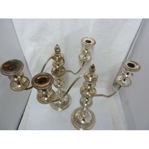 6 - A pair of silver plated twisted arm candelabra, three light, the central sconce with removable flame... 