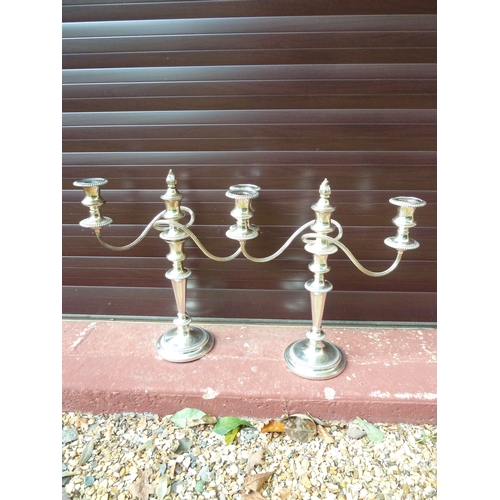 6 - A pair of silver plated twisted arm candelabra, three light, the central sconce with removable flame... 