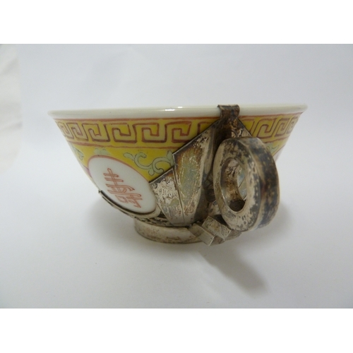 78 - A Chinese porcelain white metal mounted cup and saucer, the porcelain teabowl decorated with good fo... 