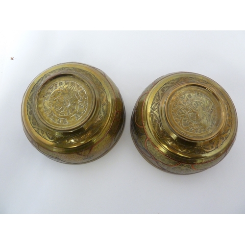 100 - A pair of Indian or Islamic brass temple bowls, richly chased and inlaid in white and copper metals ... 