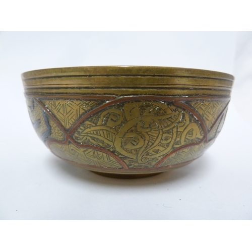 100 - A pair of Indian or Islamic brass temple bowls, richly chased and inlaid in white and copper metals ... 