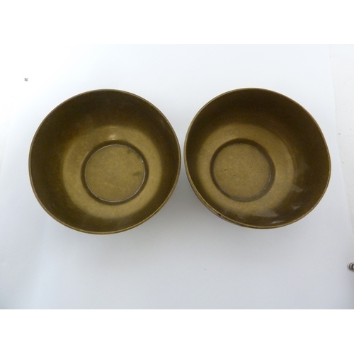 100 - A pair of Indian or Islamic brass temple bowls, richly chased and inlaid in white and copper metals ... 