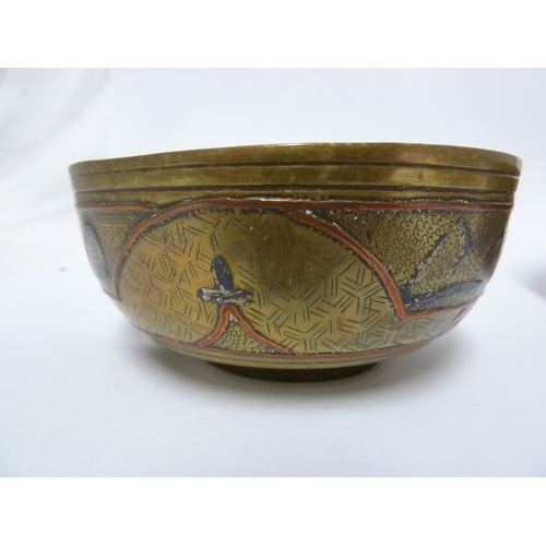 100 - A pair of Indian or Islamic brass temple bowls, richly chased and inlaid in white and copper metals ... 