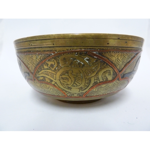 100 - A pair of Indian or Islamic brass temple bowls, richly chased and inlaid in white and copper metals ... 