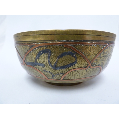 100 - A pair of Indian or Islamic brass temple bowls, richly chased and inlaid in white and copper metals ... 