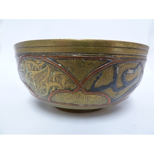 100 - A pair of Indian or Islamic brass temple bowls, richly chased and inlaid in white and copper metals ... 