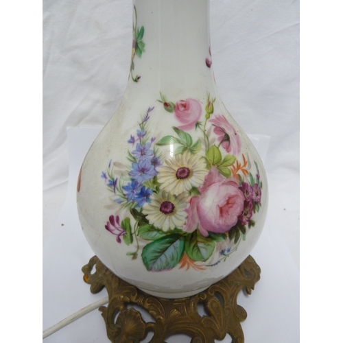 57 - A porcelain lamp base, of bottle form painted with bouquets of Summer flowers on a white ground, Fre... 