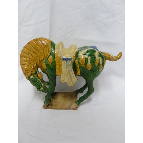 146 - A Chinese Tang pottery Horse, the Fereghana horse standing four square with flowing caparison on a t... 