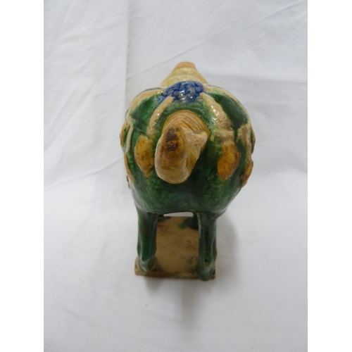 146 - A Chinese Tang pottery Horse, the Fereghana horse standing four square with flowing caparison on a t... 