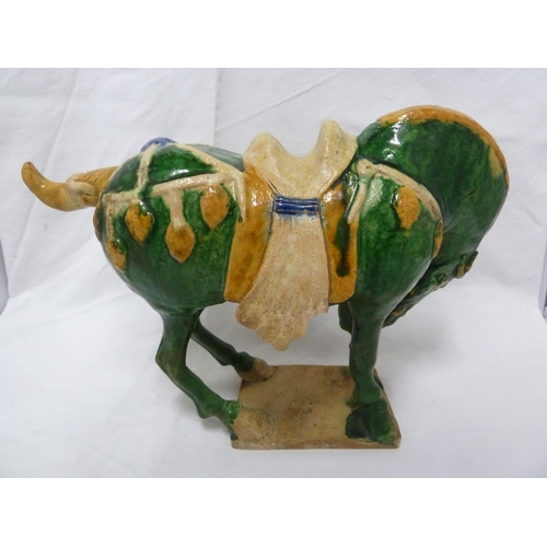 146 - A Chinese Tang pottery Horse, the Fereghana horse standing four square with flowing caparison on a t... 