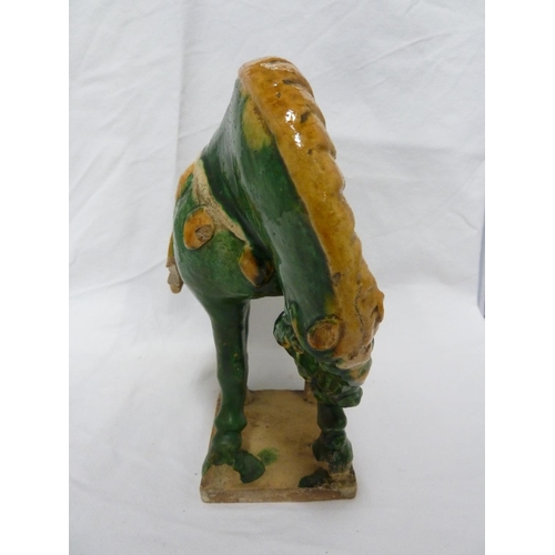 146 - A Chinese Tang pottery Horse, the Fereghana horse standing four square with flowing caparison on a t... 