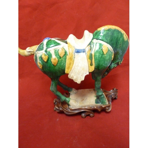 146 - A Chinese Tang pottery Horse, the Fereghana horse standing four square with flowing caparison on a t... 