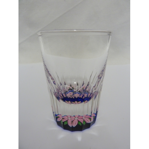 109 - A small Perthshire paperweight cane beaker, the base decorated with canes about a central clematis t... 