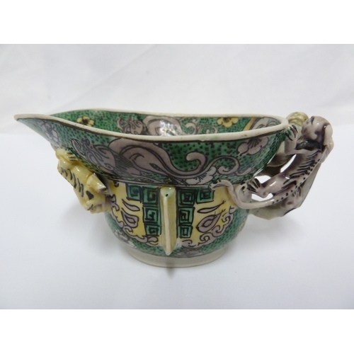 110 - A Chinese porcelain libation cup, decorated in famille verte  with Chilong dragons, after an archais... 