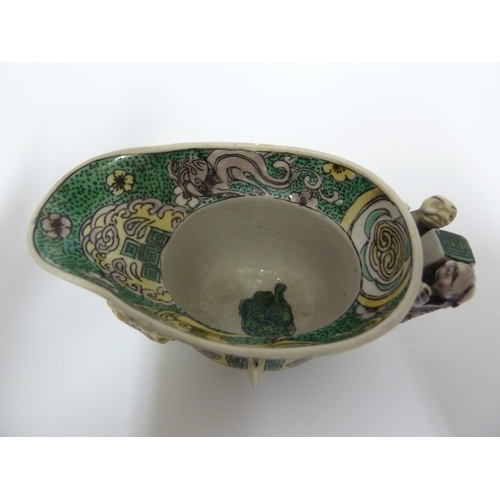 110 - A Chinese porcelain libation cup, decorated in famille verte  with Chilong dragons, after an archais... 