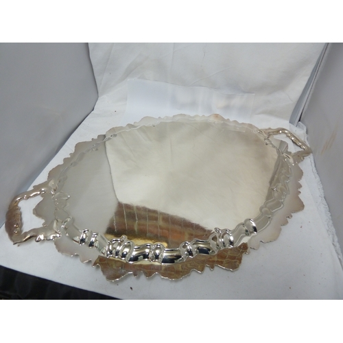 12 - A shell edge silver plated drinks tray, oval between similarly decorated handles, 62 cm max approx.