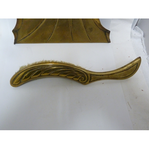 120 - A brass mounted crumb scoop and brush, of nautilus shell pattern (2)