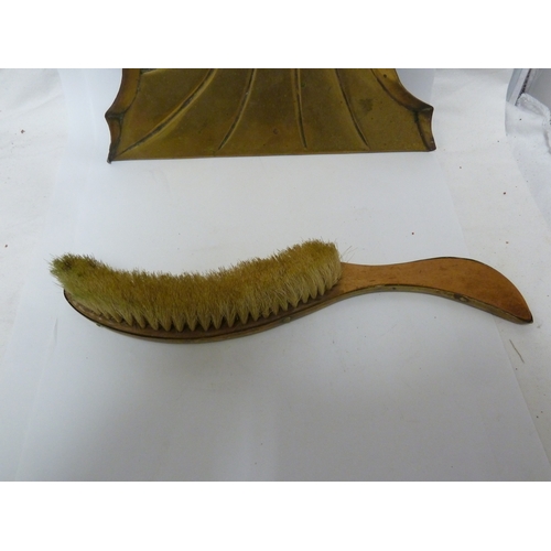 120 - A brass mounted crumb scoop and brush, of nautilus shell pattern (2)