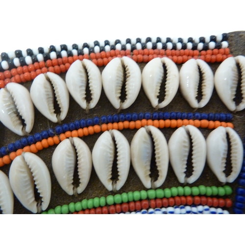 145 - A collection of Massai glass beaded necklets, in bright colours and with shell decoration, African, ... 