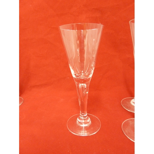 36 - Seven Dartington Sharon pattern glass flutes, acid etched Dartington mark to underside of each foot.... 